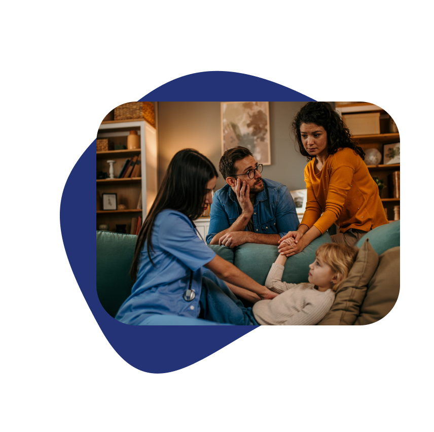 Mom, dad, and sick daughter in hotel room with nurse providing in-room medical consultation.