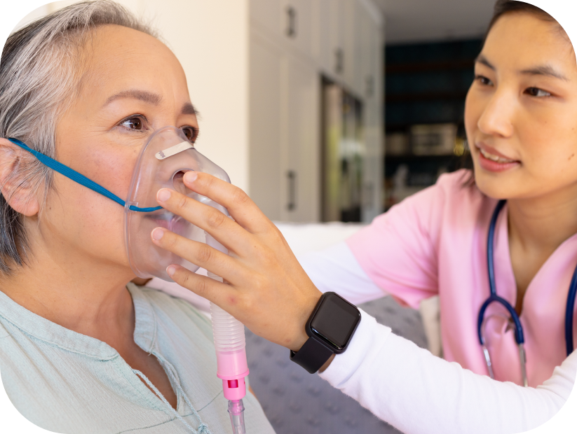Nurse assisting a woman with breathing in a hotel room providing In-Room Medical Service