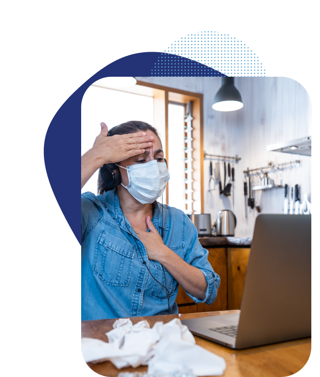 Female patient in hotel room checking her temperature while talking to a doctor on a telemedicine call.