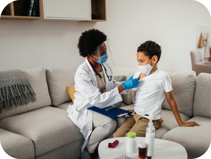 Doctor examining a young boy in a resort room with In-Room Medical Service
