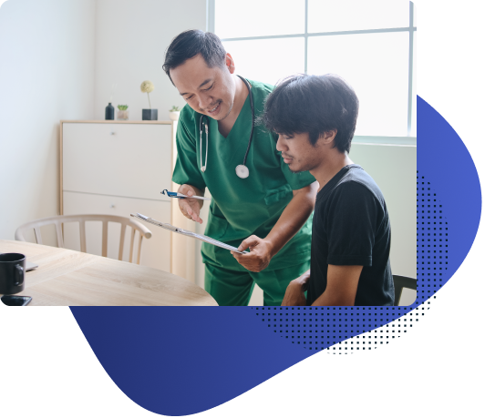 Male nurse explaining diagnosis to a young patient during in-room medical service